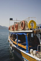 Gulet style day trip boat moored on calm sea in early Summer season.Turkish Rivieracoastcoastalresortsunshineholidaydestinationwater taxiDestination Destinations European Holidaymakers Middl...