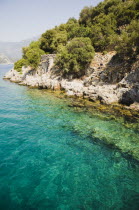 Olu Deniz.  Clear  aquamarine water off Gemiler or St Nicholas island with Byzantine ruins under surface.Turkish rivieraAegeancoastcoastalseacalmshallowOttomanByzantineazureSummergreenblu...