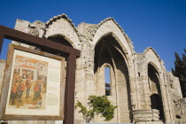 Rhodes Old Town.  Ruin of Byzantine era Church of the Virgin in UNESCO World Heritage Site with information sign in foreground.Aegeancoastcoastalformer Ottoman territorylocation for Guns of Navar...