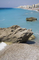 Deserted beach with rocks and clear  shallow  aquamarine water at Ixia beach resort looking East towards Rhodes Town.Aegeancoastcoastalformer Ottoman territorylocation for Guns of NavaroneRodiS...