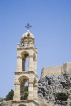 Lindos.  Church belltower with Akropolis castle ruins on hilltop behind AegeanGreekSummer seasonRodicoast coastalpackage holidaytrip destinationDestinations ElladaSouthern EuropeAcropolisci...