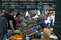 St Georges Market on a busy friday morning  busy with shoppers. Stalls selling fruit and vegetables.Beal Feirste Eire European Irish Northern Northern Europe Republic Ireland Poblacht na hEireann Imm...