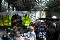 St Georges Market on a busy friday morning  busy with shoppers. Stalls selling clothing and workwear.Beal Feirste Eire European Irish Northern Northern Europe Republic Ireland Poblacht na hEireann Ol...