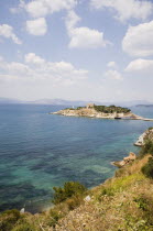 Kusadasi.  View towards Pigeon Island or Guverin Ada from Kusadasi clifftop in early Summer season.AegeanCoast CoastalSeaHolidayResort Destination Destinations European Middle East Salt Water Wav...