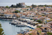 Pythagorio.  View over harbour and waterfront buildings with line of moored yachts and fishing boats.North Eastern AegeanGreek IslandsPithagorion Pythagorioncoast coastalseaSummerpackageholida...