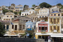 Yialos.  Pastel coloured facades of waterfront buildings overlooking harbour.AegeanGreek IslandsSimicoast coastalseaSummerpackageholidayresortvacationtripdestinationDestinations ElladaEu...