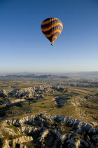 Turkey, Cappadocia, Goreme, Hot air balloons in flight over landscape, Hot air balloon in flight over the landscape in early morning.