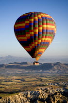 Turkey, Cappadocia, Goreme, Hot air balloons in flight over landscape, Hot air balloon in flight over the landscape in early morning.