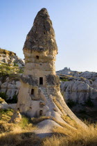 Turkey, Cappadocia, Goreme, A Fairy Chimney on the edge of town with Uchisar behind.