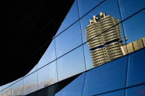 Germany, Bavaria, Munich, BMW Headquarters and museum reflected in BMW Welt, World.