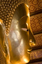 Thailand, Bangkok, Wat Pho, Wat Phra Chetuphon, Close up of the face of the large reclining buddha statue.