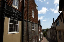 England, East Sussex, Lewes, High Street, Keere Street cobbled pathway with traditional buildings.