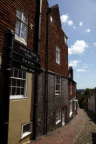 England, East Sussex, Lewes, High Street, Keere Street cobbled pathway with traditional buildings.