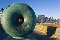 England, East Sussex, Brighton, The green bronze Doughnut sculpture on one of the groynes on the seafront.