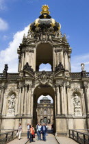 GERMANY, Saxony, Dresden, The Crown Gate or Kronentor of the restored Baroque Zwinger Palace with tourists walking through originally built between 1710 and 1732 after a design by Matthus Daniel Ppp...