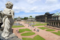 GERMANY, Saxony, Dresden, The central Courtyard of the restored Baroque Zwinger Palace gardens busy with tourists seen from the statue lined Rampart originally built between 1710 and 1732 after a desi...