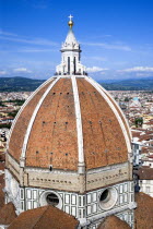 ITALY, Tuscany, Florence, The Dome of the Cathedral of Santa Maria del Fiore the Duomo by Brunelleschi with tourists on the viewing platform looking over the city towards the surrounding hills.