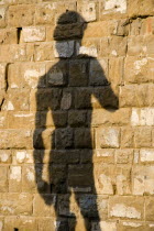 ITALY, Tuscany, Florence, Shadow of the replica Renaissance statue of David by Michelangelo on the wall of the Palazzo Vecchio in the Piazza della Signoria.