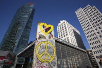 Germany, Berlin, section of the Berlin wall & railway station entrance at Potsdamer Platz.