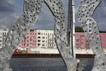 Germany, Berlin, Detail of Molecule Men sculpture 30 metres in height by Jonathan Borofsky on River Spree.