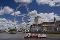 England, London, South Bank, London Eye and Aquarium from Westminster Bridge with tourist boat in foreground. 