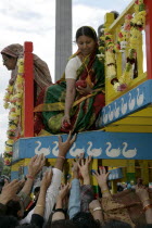 Religion, Hindu, Worship, London Rathayatra celebrations in Trafalgar Square. People handing out offerings during festival.