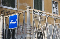 Italy, Veneto, Venice, Centro Storico, Gondola access via iron stairway indicated with tourist sign in blue and white.