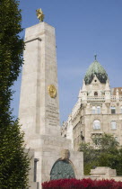 Hungary, Pest County, Budapest, WWII memorial with Art Nouveau building facade behind.