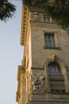 Hungary, Pest County, Budapest, part view of exterior facade of building with bas relief carving of metal workers.