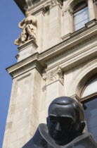 Hungary, Pest County, Budapest, detail of bronze statue in front of art nouveau building facade.