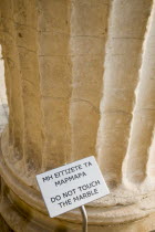 Greece, Attica, Athens, Acropolis Propylaea gate, part view with Do not touch the Marble sign.