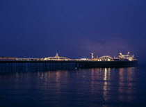 England, East Sussex, Brighton Pier illumintaed at night.