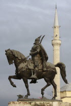 Albania, Tirana, Statue of Skanderbeg, the national hero, with the Ethem Bey mosque in the background.