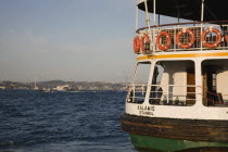 Turkey, Istanbul, Sultanahmet, Ferry flying Turkish flag on the Bosphorous with bridge behind. Since March 2006, Istanbuls traditional commuter ferries have been operated by Istanbul Sea Buses. 