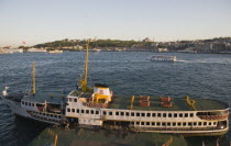 Turkey, Istanbul, Sultanahmet, Bosphorous passenger ferry moored at sunset with the Hagia Sophia behind.