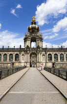 GERMANY, Saxony, Dresden, The Crown Gate or Kronentor of the restored Baroque Zwinger Palace with tourists walking through originally built between 1710 and 1732 after a design by Matthus Daniel Ppp...