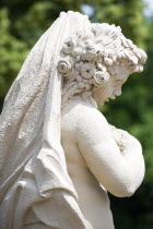 GERMANY, Saxony, Dresden, Statue of a cherub in the restored Baroque Zwinger Palace Gardens.