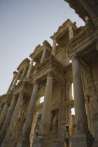 Turkey, Izmir Province, Selcuk, Ephesus, Roman Library of Celsus facade with young woman standing in doorway.