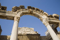 Turkey, Izmir Province, Selcuk, Ephesus, Carved archway, supporting columns and wall frieze in antique city of Ephesus on the Aegean sea coast. 