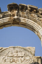 Turkey, Izmir Province, Selcuk, Ephesus, Detail of carved archway and wall relief against clear blue sky in ancient city of Ephesus on the Aegean sea coast. 