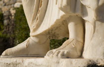 Turkey, Izmir Province, Selcuk, Ephesus, Detail of feet of marble statue in ancient city of Ephesus on the Aegean sea coast. 