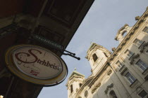 Austria, Vienna, Circular bar sign with Empire era building facade behind. 