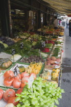 Austria, Vienna, The Naschmarkt, Display of fresh fruit, vegetables and herbs for sale outside shopfront, under awning.    