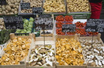 Austria, Vienna, The Naschmarkt, Fresh produce stall with display including potatoes, mushrooms, tomatoes and squash. 