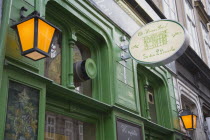 Austria, Vienna, Art Nouveau facade, painted green with decorative metal lanterns.     