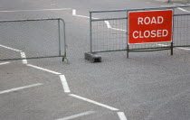 Transport, Road, Signs, Red Road Closed Traffic sign on barrier across empty urban road in Bognor Regis.