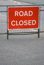 Transport, Road, Signs, Red Road Closed Traffic sign on barrier across empty urban road in Bognor Regis.