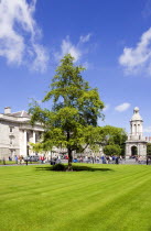 Ireland, County Dublin, Dublin City, Trinity College university with people walking through Parliament Square towards the Campanile.