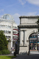 Ireland, County Dublin, Dublin City, Saint Stephens Green shopping arcade and Fusiliers Arch entrance into the park with people.