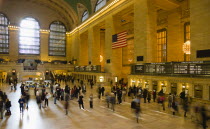 USA, New York, Manhattan, Grand Central Terminal railway station with people walking in the Main Concourse and passengers buying tickets.